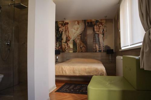 a bedroom with a bed and a painting on the wall at The Empress apartment Belgrade in Belgrade
