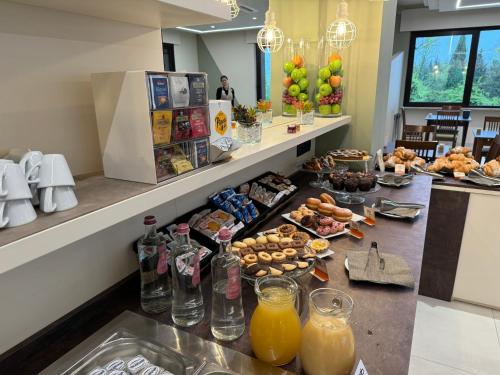 a breakfast buffet with food and drinks on a counter at Ile Hotel in Peschiera del Garda
