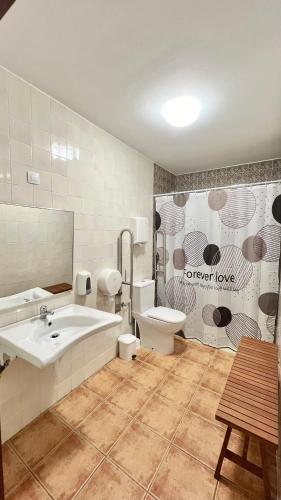 a bathroom with a tub and a toilet and a sink at Albergue de Sonia in Finisterre