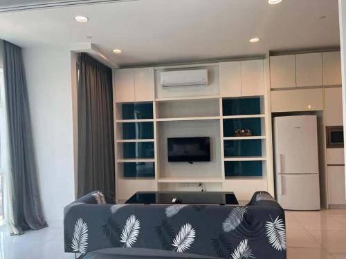 a living room with a couch and a television at Vinson Suites at Platinum KLCC in Kuala Lumpur