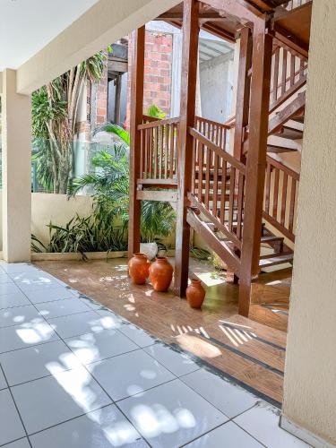 a porch with orange pumpkins on the floor at Mansomar in Jericoacoara