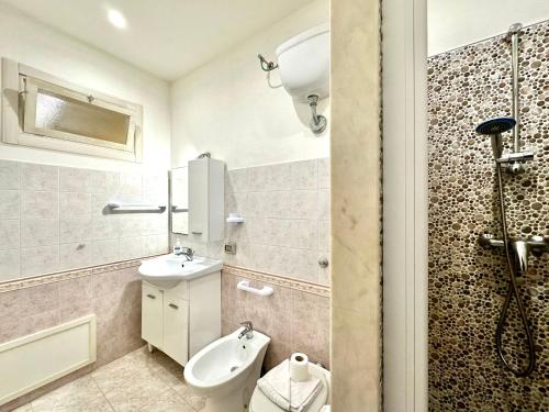 a bathroom with a toilet and a sink and a shower at Il Rifugio Del Marinaio By Housilia in Cefalù