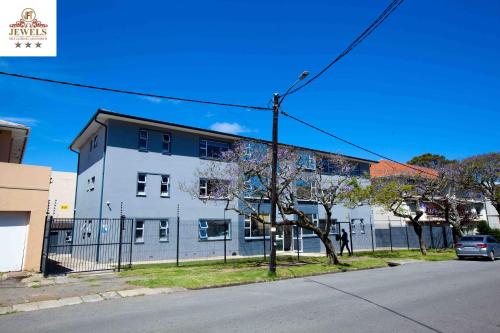 a white building on the side of a street at JFT self catering units in East London