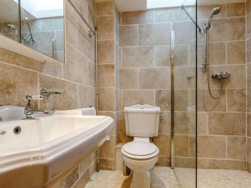 La salle de bains est pourvue de toilettes, d'un lavabo et d'une douche. dans l'établissement 2 Bed in South Molton 86642, à Knowstone