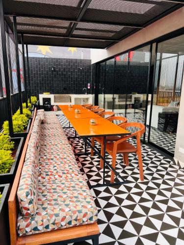 a cafeteria with a table and chairs on a checkered floor at MONTERRICO POLO APARTS #13 - DPTO 2 dorm - Frente Embajada USA in Lima