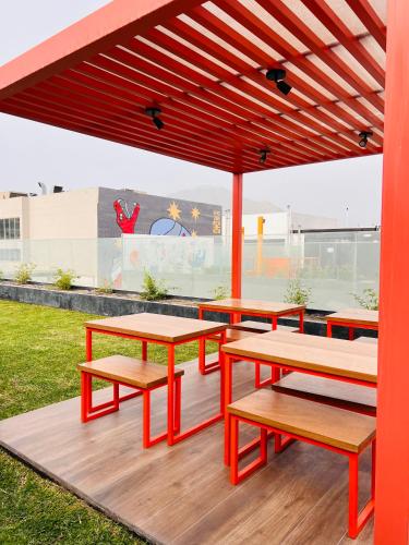 a group of picnic tables and benches on a deck at MONTERRICO POLO APARTS #13 - DPTO 2 dorm - Frente Embajada USA in Lima