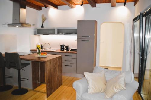 a kitchen and a living room with a couch and a table at UrbanApartment5 in Čakovec
