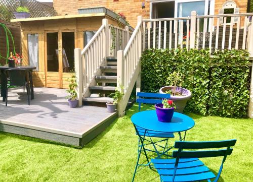 a patio with two chairs and a table in the grass at The number one in Henley on Thames