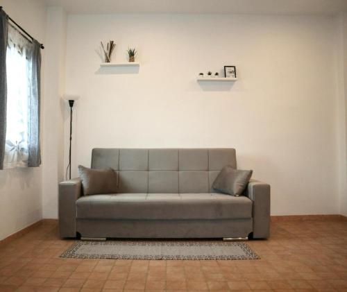 a living room with a couch and a window at Ale Apartment in Rome