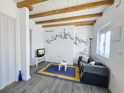 a living room with a couch and a tv at Casa de Lupa - Camariñas - Costa da Morte in A Coruña