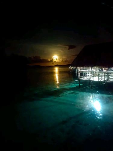 a view of the ocean at night with the moon at Bonwau West Waigeo in Minyaifuin