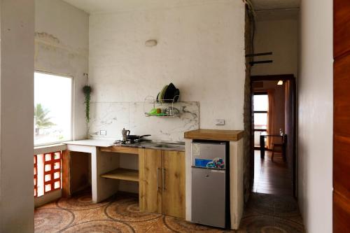 a kitchen with a sink and a counter top at Alma Olon in Olón