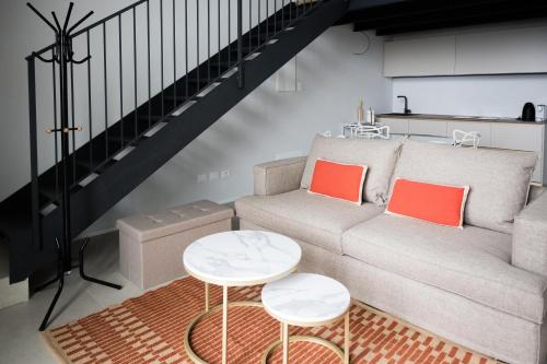 a living room with a couch and a table at Panorama Loft Apartments in Stresa