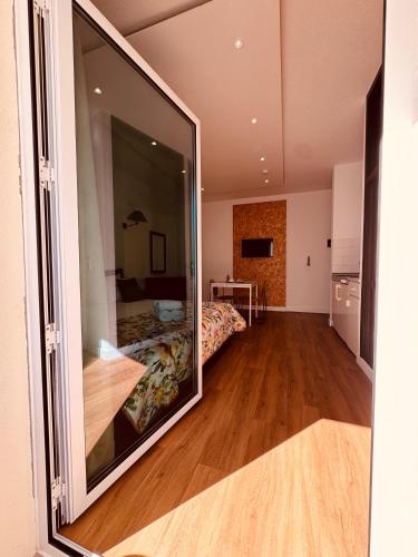 a room with a bed and a large mirror at VALE MAR Guest in Ribeira Brava