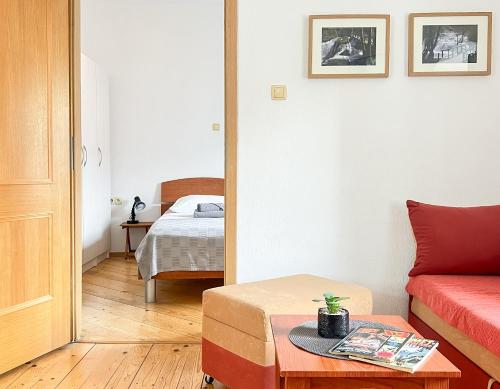 a room with a bed and a table and a room with a couch at TerraMar Apartments in Baška Voda