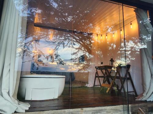 a bathroom with a bath tub and a window at Suítes Domo do Matto in Garanhuns