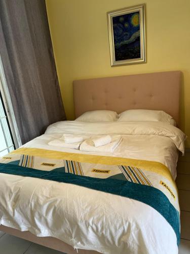 a bed with two towels on top of it at Qqueen House in Piraeus