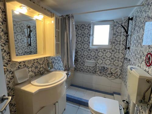 a bathroom with a toilet and a sink at Qqueen House in Piraeus