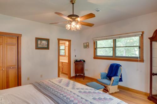 a bedroom with a bed and a fan and a chair at Beautiful Toledo Bend Retreat with Private Dock in Many