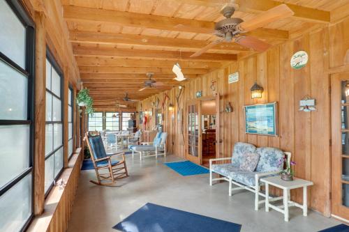 a living room with wooden walls and a ceiling at Beautiful Toledo Bend Retreat with Private Dock in Many
