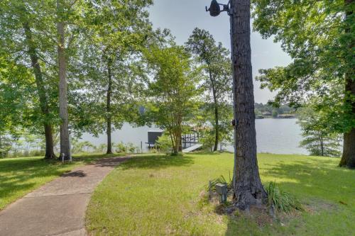 a path in a park next to a body of water at Beautiful Toledo Bend Retreat with Private Dock in Many