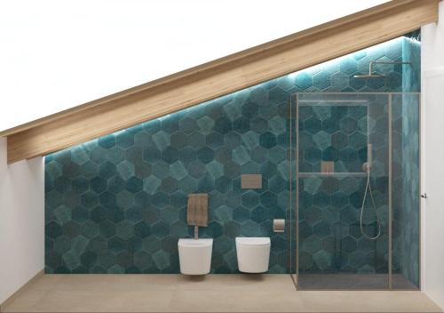 uma casa de banho com uma parede em azulejo verde e 2 WC em BIOAGRITURISMO FALEZZE em Lione