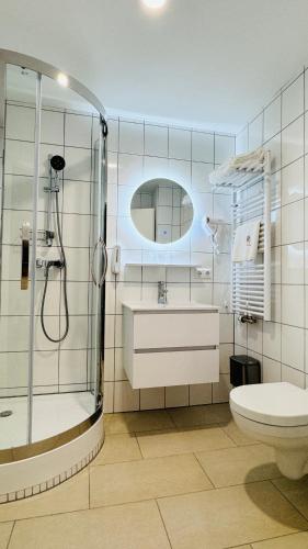 y baño con ducha, lavabo y aseo. en Hotel Libers, en Lauterbach
