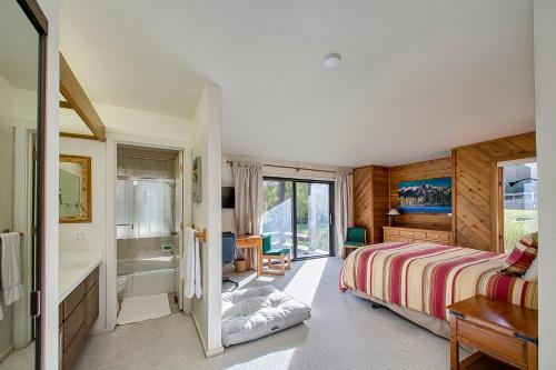 Teleidoscope Retreat في سون فالي: غرفة نوم مع سرير وحوض استحمام ومغسلة