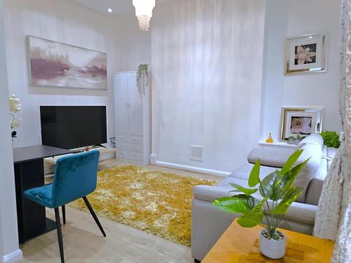 a living room with a couch and a tv at Botanic Residence in Liverpool
