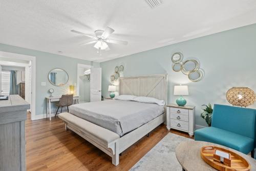 a bedroom with a bed and a blue chair at 2 BR Home in St Andrews, Close to Everything in Panama City