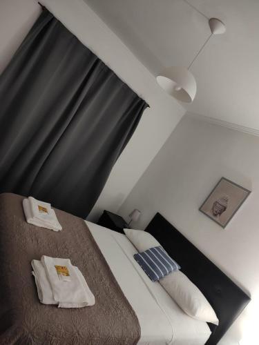 a bedroom with a bed with two towels on it at Ezeiza Home in Ezeiza