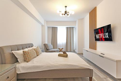 a living room with a bed and a chair at Ada Homes 07 in Braşov