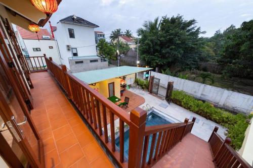 a balcony of a house with a swimming pool at Lama Beach Villa in An Bang