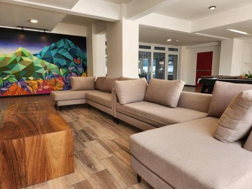 a living room with two couches and a pool table at La Floresta - Mejor opción relación calidad precio in Quetzaltenango