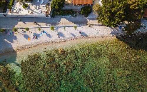an overhead view of a beach with people in the water at Apartments Mamma Mia in Orebić
