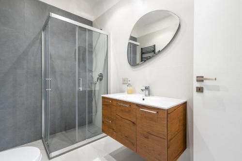 ein Bad mit einer Dusche, einem Waschbecken und einem Spiegel in der Unterkunft aura in Monte Porzio Catone
