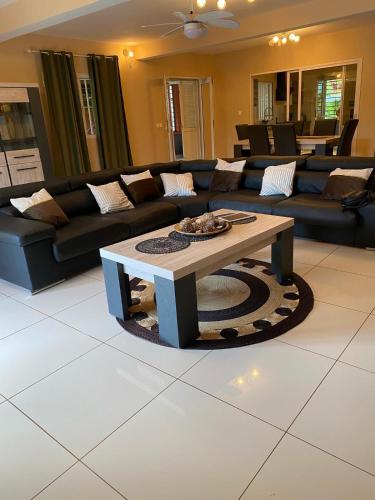 a living room with a couch and a coffee table at Maison Villa Dagoni in Koungou