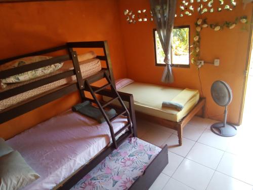 a bedroom with two bunk beds and a window at Cocibolca House B&B in Altagracia