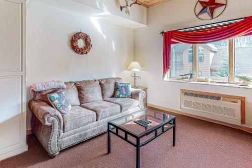 a living room with a couch and a table at Gateway #5055 in Keystone