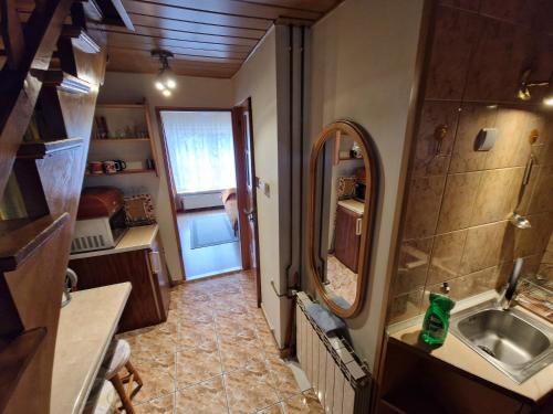 a small bathroom with a sink and a mirror at Pokój pod lasem u Ewki in Zakopane