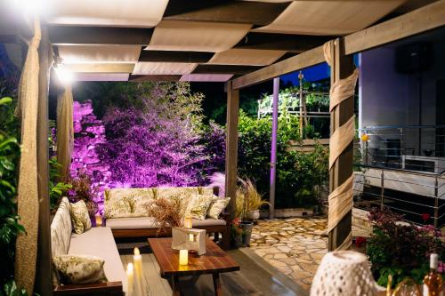 a patio with a couch and a table at Niriides Apartments in Kourouta