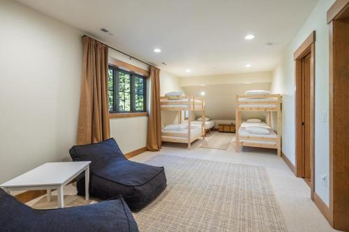 a living room with a couch and a table and bunk beds at Suncadia 4 Bdrm New Home At Nelson Preserve in Cle Elum