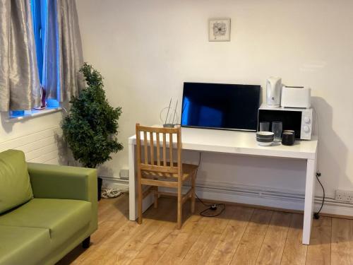 a desk with a computer on it with a monitor at Overton in London