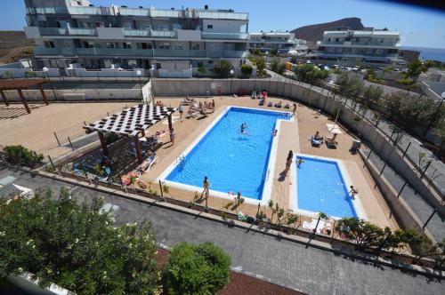 an overhead view of a swimming pool in a resort at Penthouse Apartment Tejita Beach in La Tejita