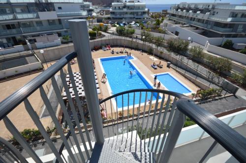 a view of a swimming pool from the balcony of a apartment at Penthouse Apartment Tejita Beach in La Tejita