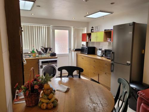 a kitchen with a table with fruit on it at Nice Double Bedroom Near QMC in Nottingham