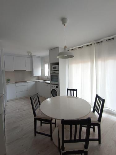 a kitchen with a table and chairs in a room at Aiguaneu S'Auguer in Blanes
