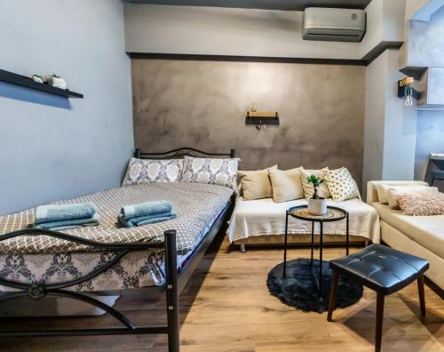 a room with a bed and a couch at Happiness studio with terrace. in Thessaloniki