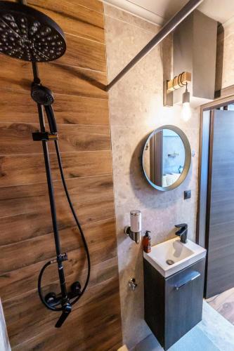 a shower in a bathroom with a sink and a mirror at Happiness studio with terrace. in Thessaloniki