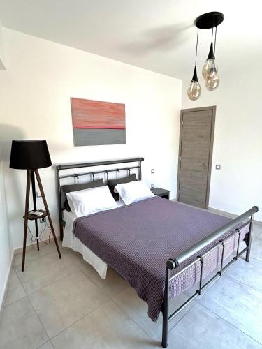 a bedroom with a large bed in a room at Bridge House Corfu in Potamós